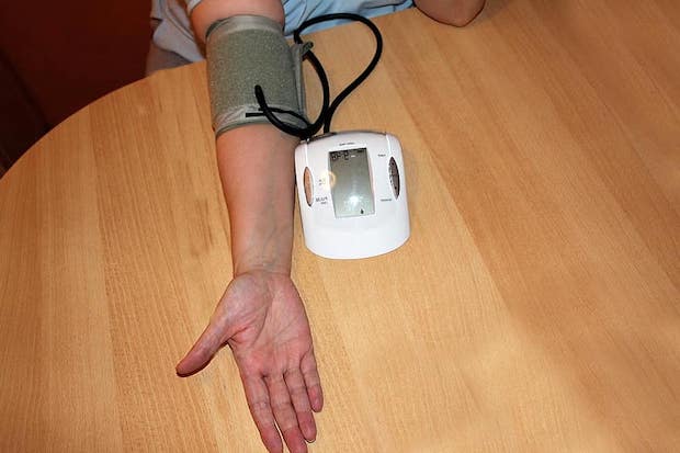 An arm hooked up to a blood pressure monitor